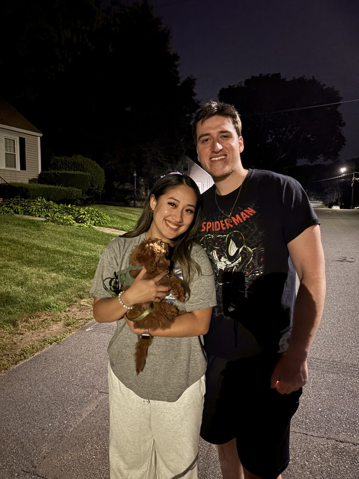Jonathan and Phung holding Rusty as a puppy